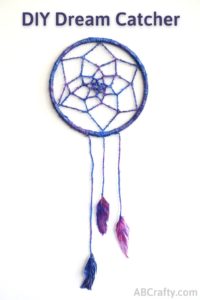 Finished galaxy dream catcher with feathers, blue, purple, and glitter
