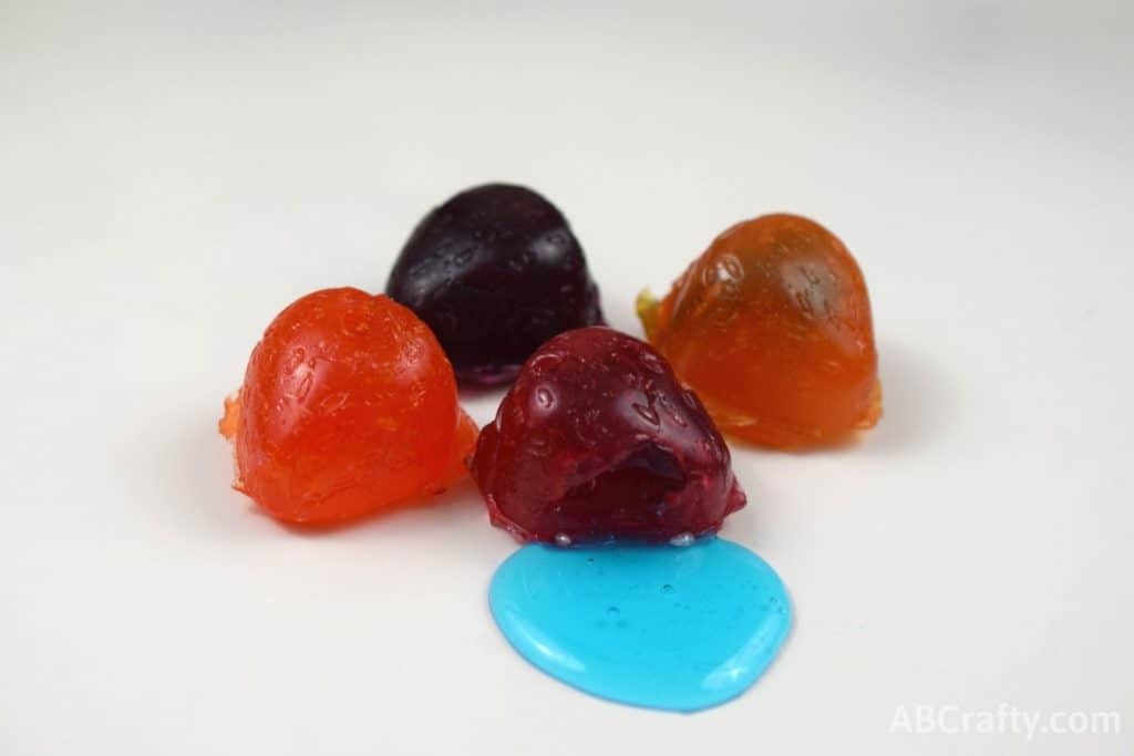 Homemade Gushers fruit candy in different colors with blue liquid candy oozing out