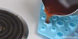 Pouring cooked candy into silicone mold
