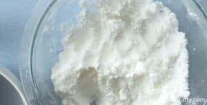 White bath bomb mixture moistened to feel like wet sand