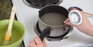 attaching candy thermometer to pot on stove