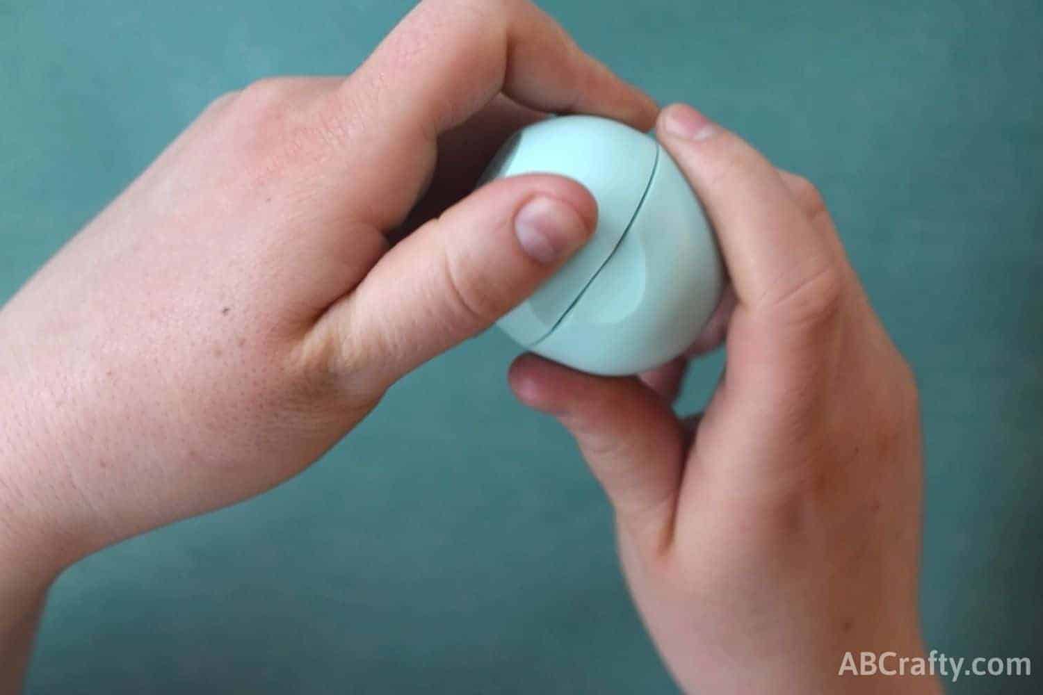 closing blue eos lip balm with hands