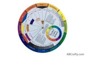 color wheel showing adding black to orange to make brown