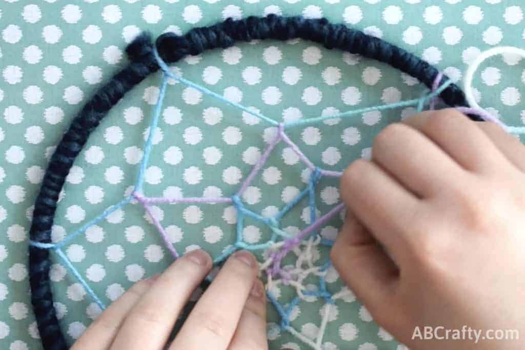 Finishing the wraps for the inside web of the dream catcher