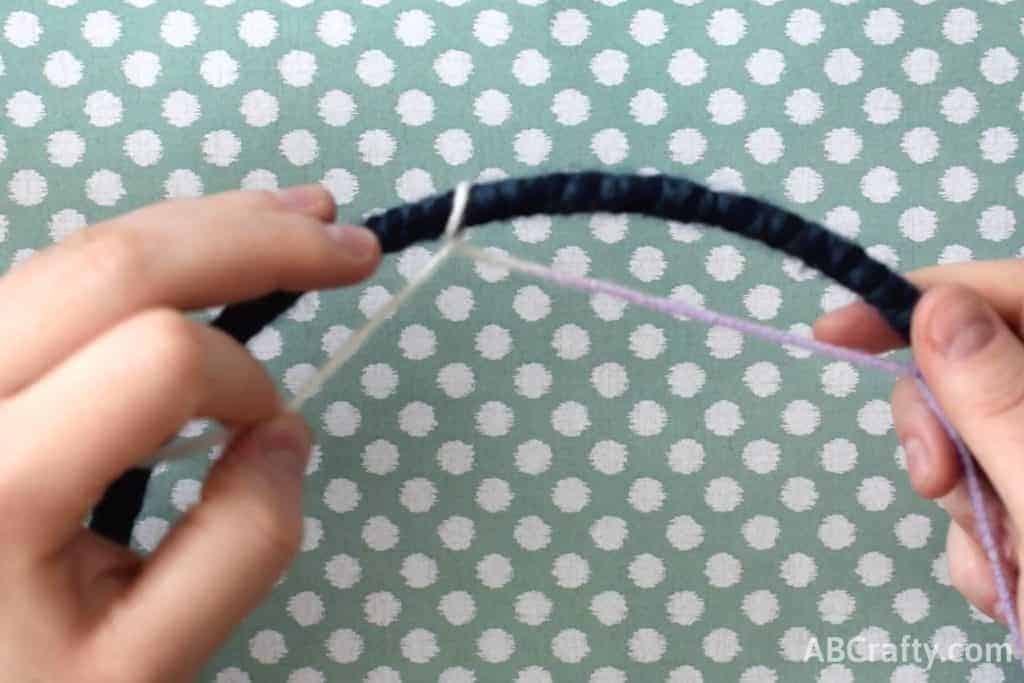 Wrapping cord around the hoop to make a loop
