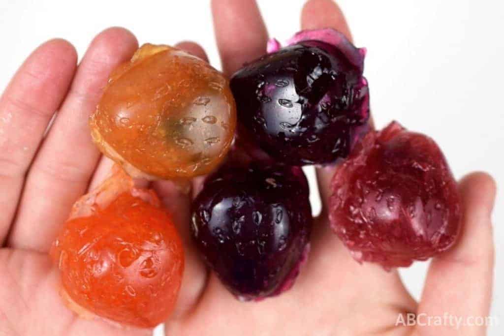 holding different colors and flavors of homemade gushers in hands