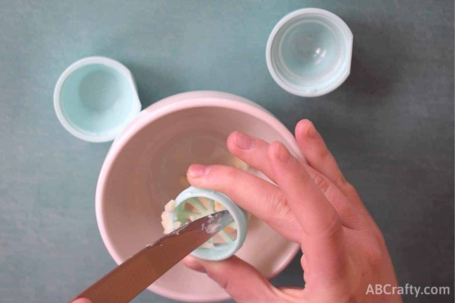 removing contents of an eos lip balm into a bowl