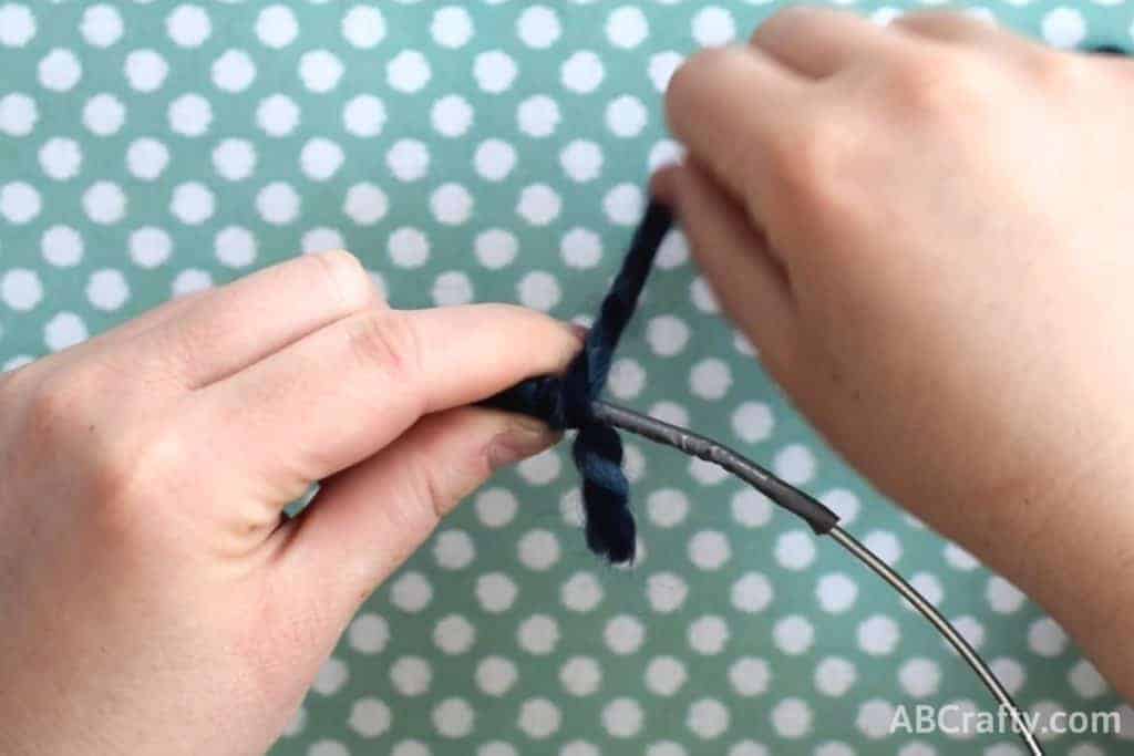 wrapping yarn over wire circle, covering the knot