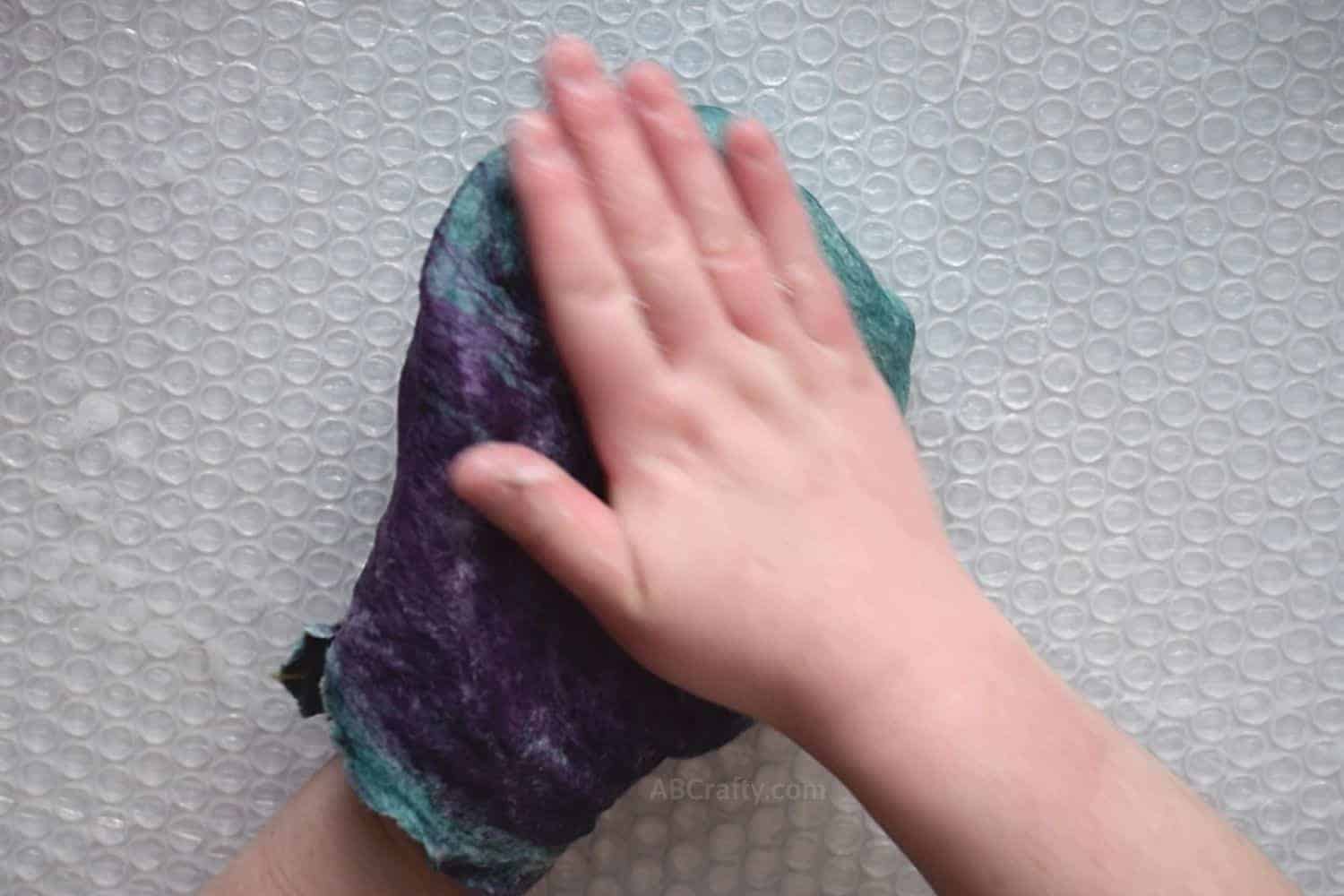 Rubbing the outside of a lightly felted pouch after flipping it inside out