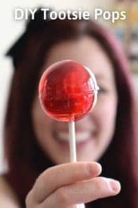 Large homemade red lollipop with a tootsie roll in the center with the title "DIY tootsie pops"