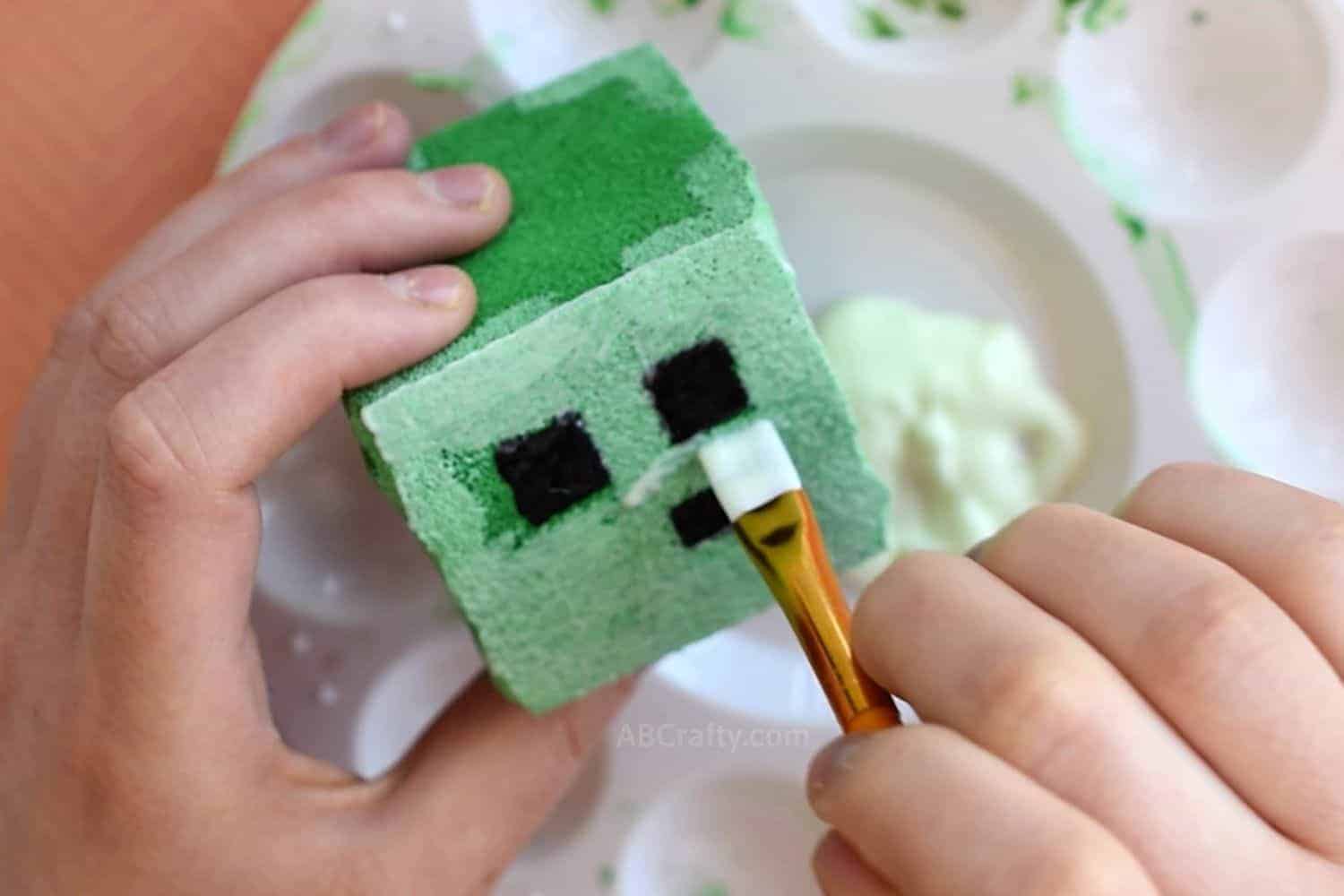 Painting Minecraft squishy slime block with glow in the dark fabric paint using a paintbrush