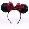 DIY Light Up Minnie Ears. It's a black sequined headband with a red sequined bow, creating the classic Disney Minnie Mouse ears