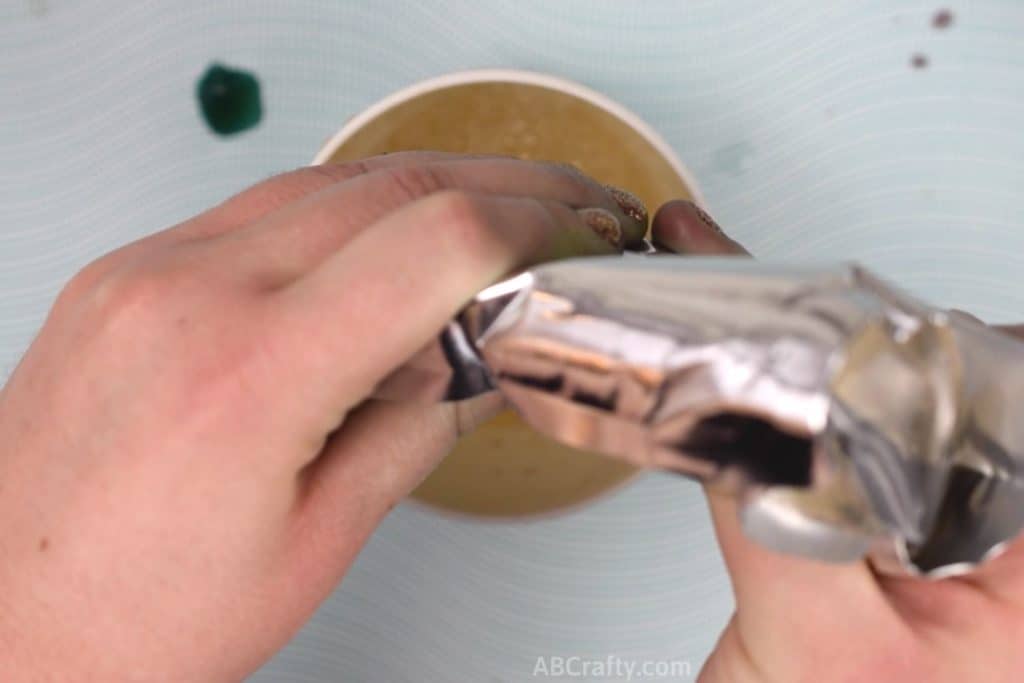 Squeezing a capri sun into a measuring cup