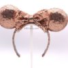 handmade rose gold minnie mouse ears on a white stand