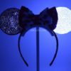 DIY disney ears inspired by 101 dalmatians and Cruella Deville lit up in the dark so that one ear is still black and the other shines white