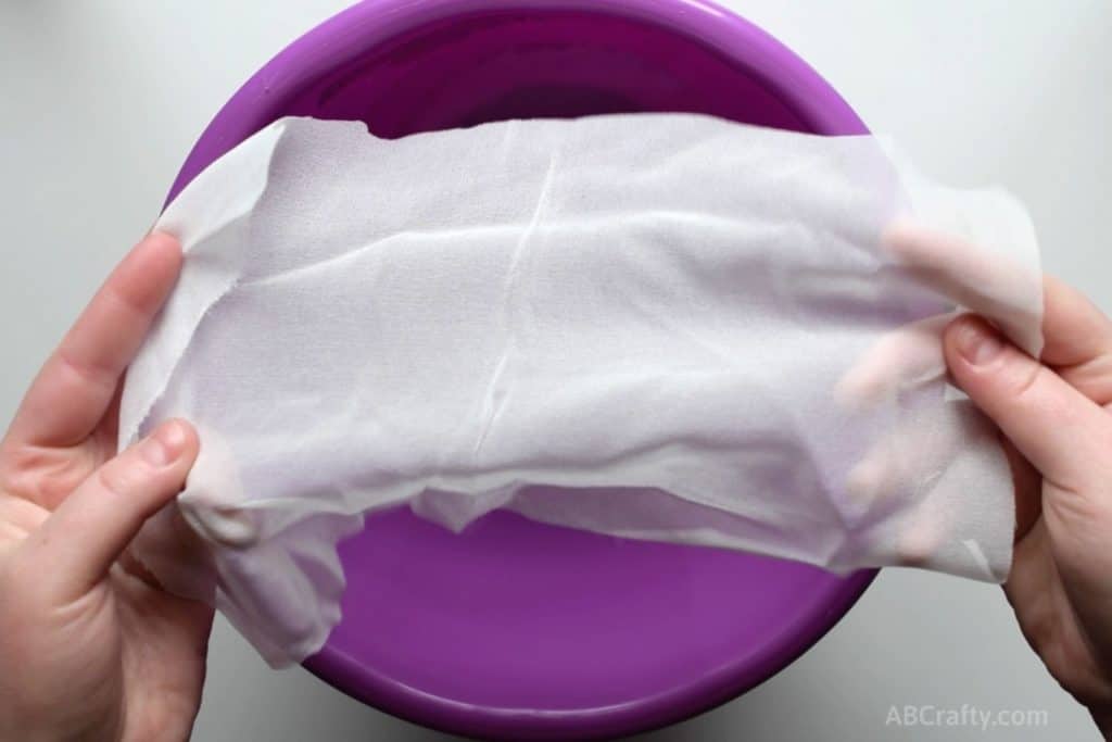 Holding a scrap habotai silk fabric over a purple bucket