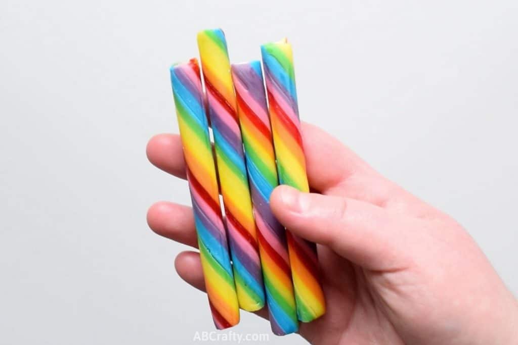 Holding rainbow candy sticks