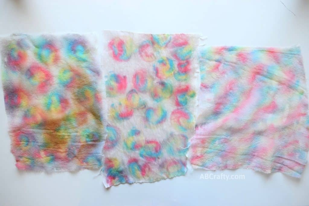 Completely dyed silk and satin fabrics revealing a rainbow tie dye effect