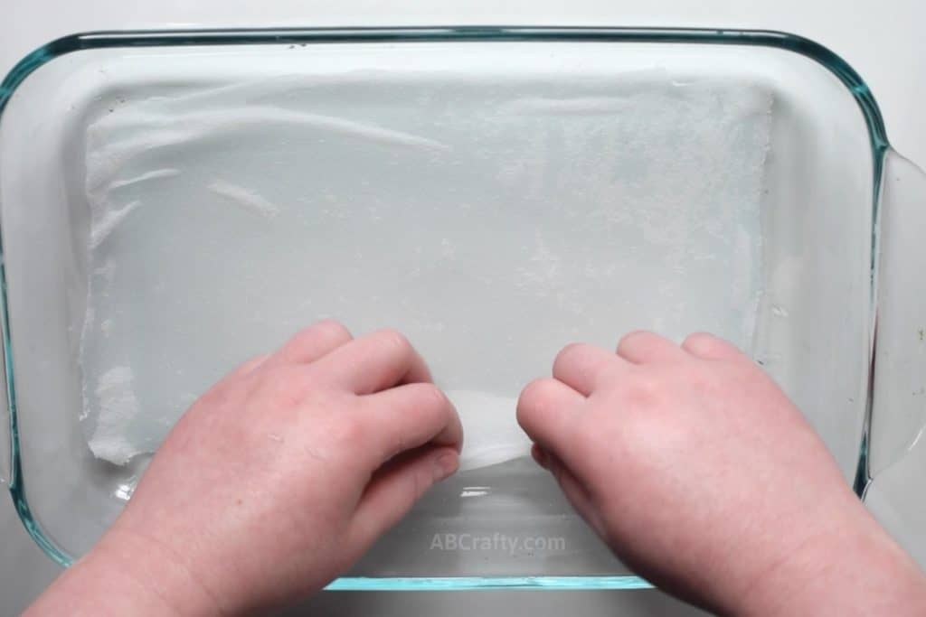 Stretching a damp habotai scrap flat across in a clear pyrex dish