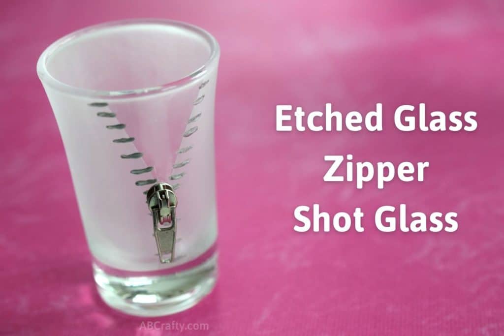 Zipper design painted silver on an etched glass frosted shot glass with a zipper pull attached. The title reads "etched glass zipper shot glass"