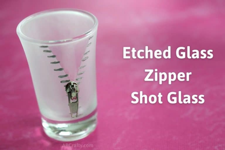 Zipper design painted silver on an etched glass frosted shot glass with a zipper pull attached. The title reads "etched glass zipper shot glass"
