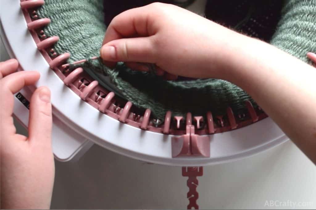 Scooping a few loops of yarn with the plastic needle