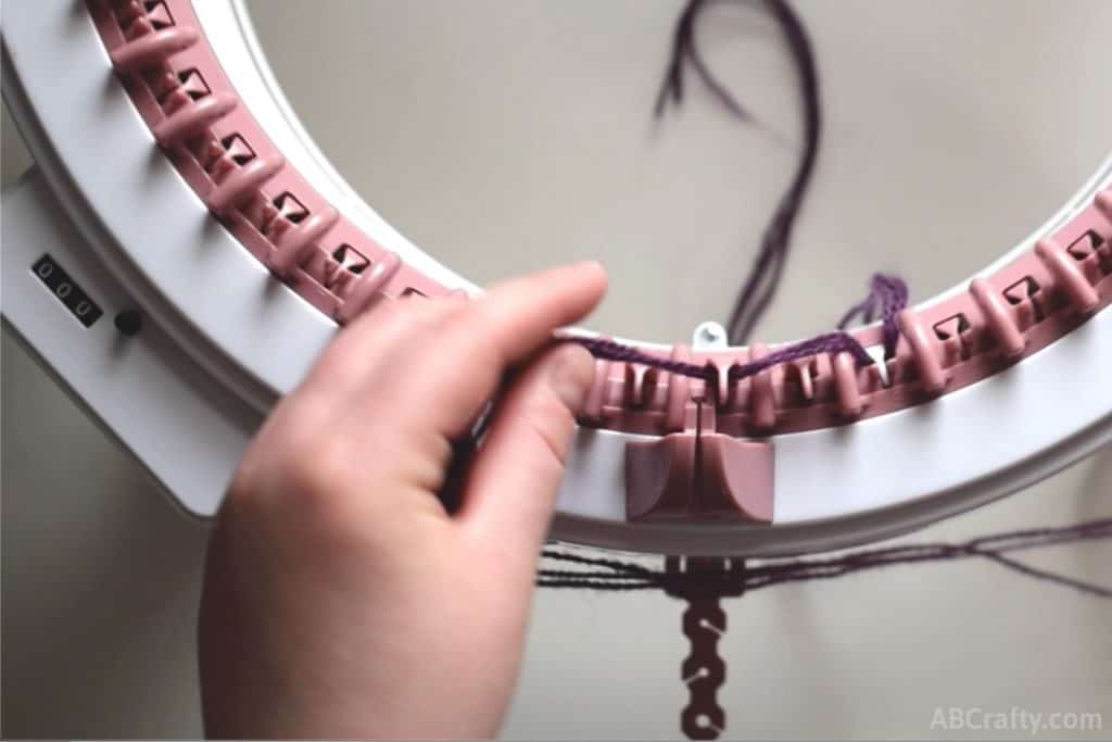 Placing the yarn in front of the third needle of the sentro knitting machine