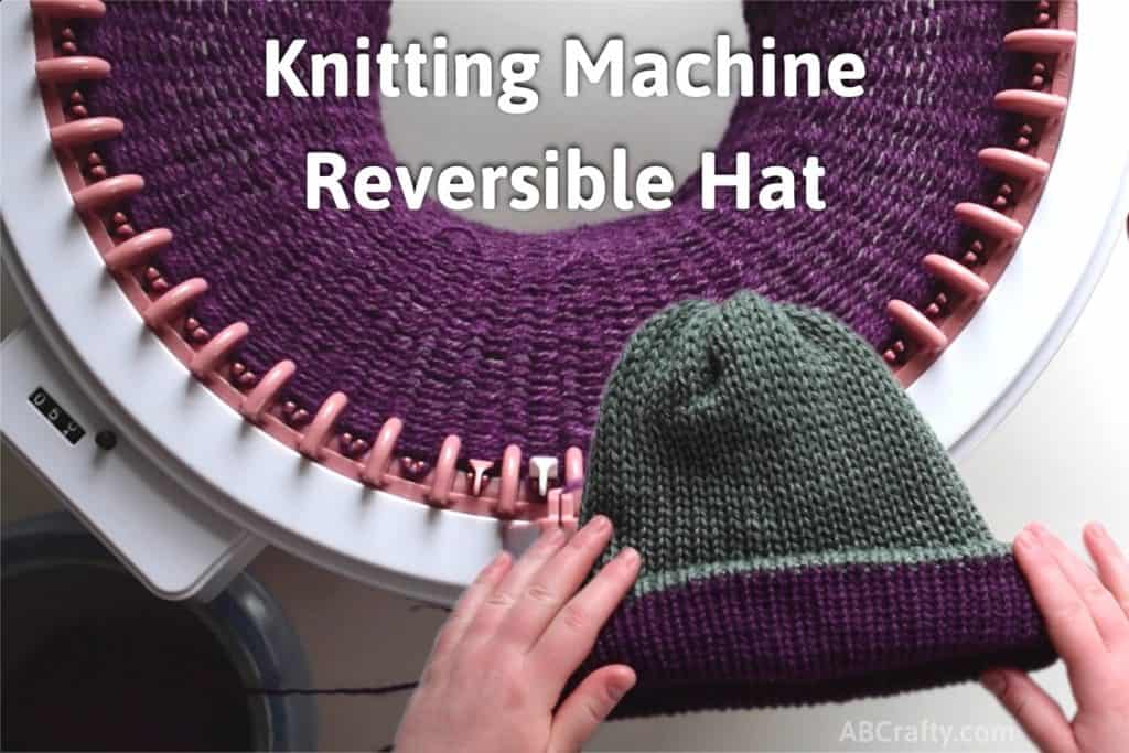 Holding a green and purple reversible knit beanie over purple yarn knit on a sentro knitting machine with the title "knitting machine, reversible hat"