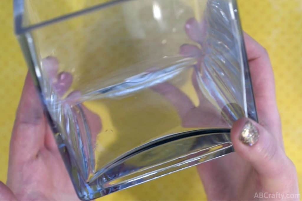 holding a square glass container in two hands
