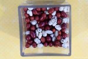 glass container filled with boston baked beans and yogurt covered raisins