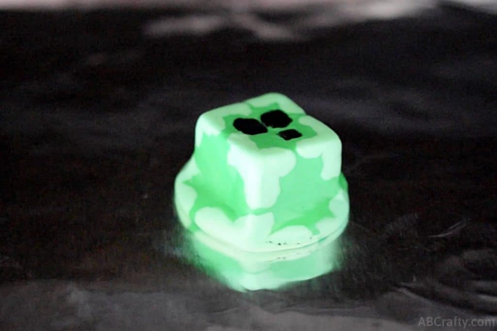 homemade eraser in the shape of a minecraft slime chunk melted on aluminum foil