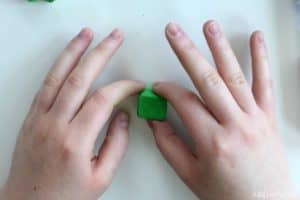 shaping green eraser clay into a cube