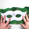 placing ab crafty masquerade mask template over green handmade felt