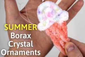 holding an ice cream cone covered in crystals with a string hanging off and the title 'summer borax crystal ornaments'