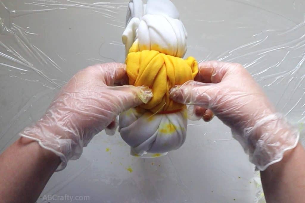 squishing a section of yellow tie dye