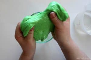 pulling a blob of green goo that has some lumps in it