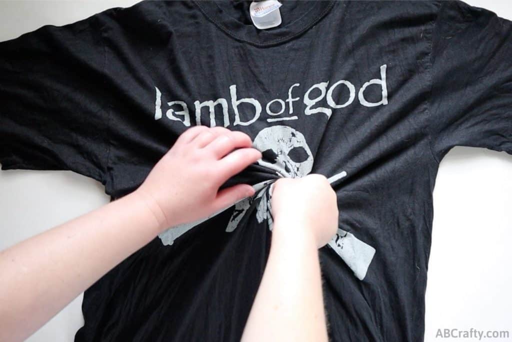 black lamb of god t shirt getting twisted from the middle