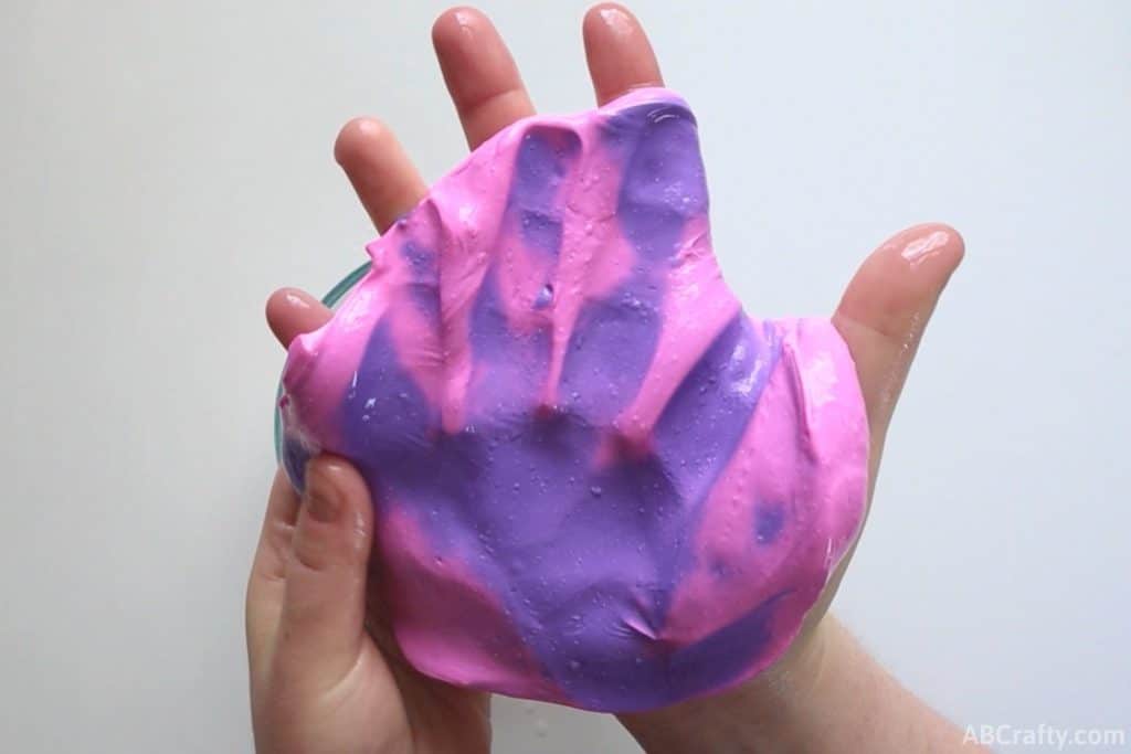 showing color changing slime with a purple handprint on the pinks slime