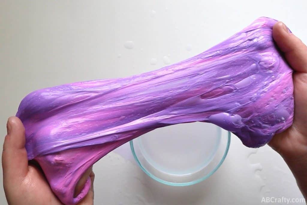 stretching color changing slime with streaks of purple and pink