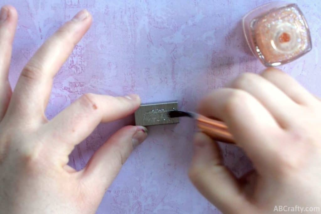 painting glitter nail polish onto staples