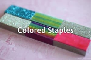 multiple sets of staples, including glitter blue staples, rainbow staples, green staples, and pink staples with the title "colored staples" on it