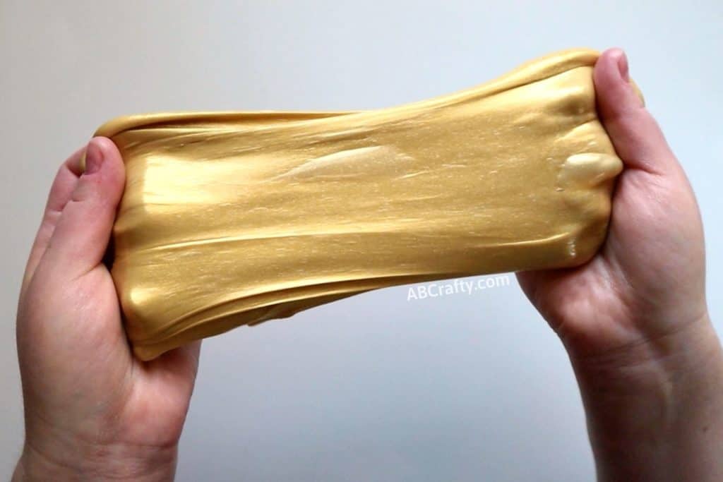 stretching smooth metallic slime with two hands