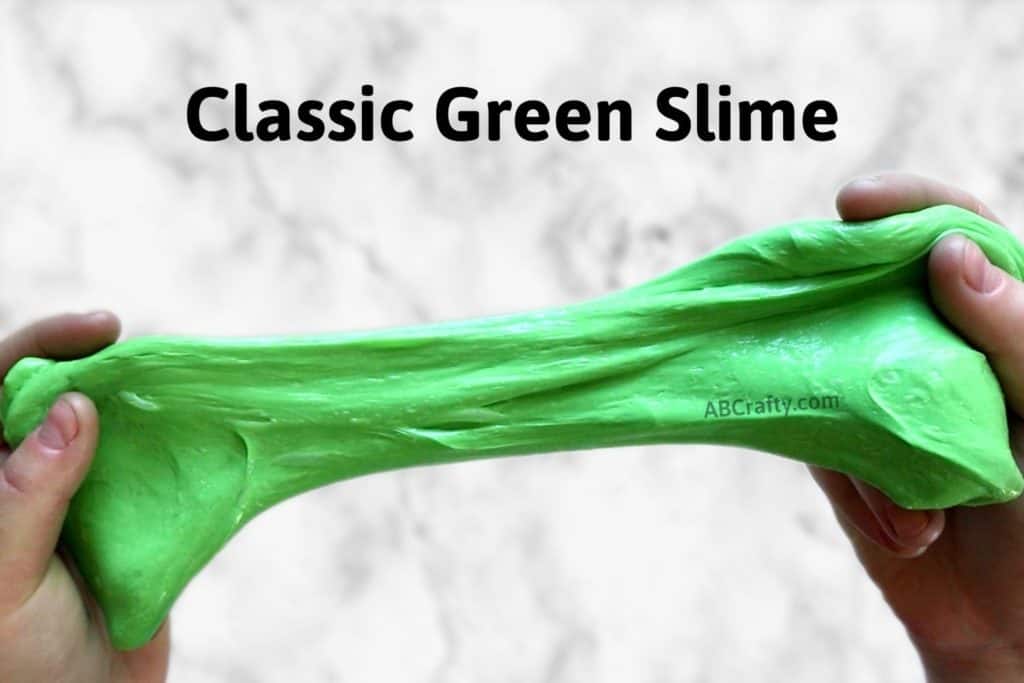 two hands stretching green slime