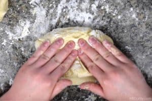 folding cookie dough over to mix in food coloring