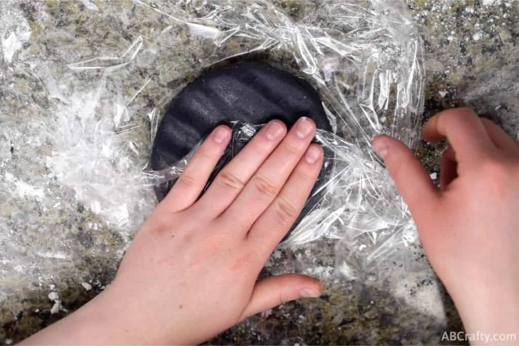 wrapping black cookie dough in plastic wrap