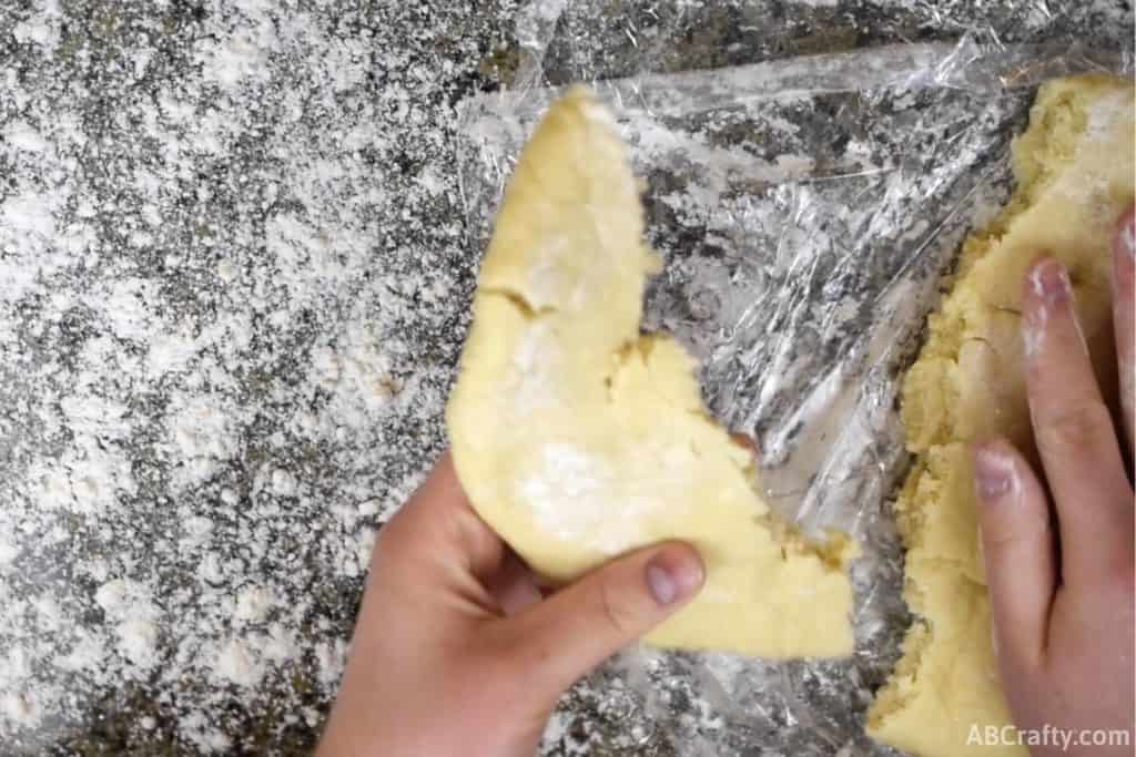 breaking a section of cookie dough