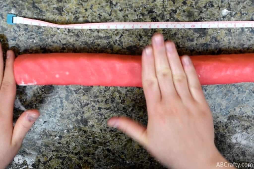 shaping red cookie dough into thick rectangle