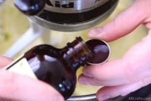 pouring vanilla extract into cap