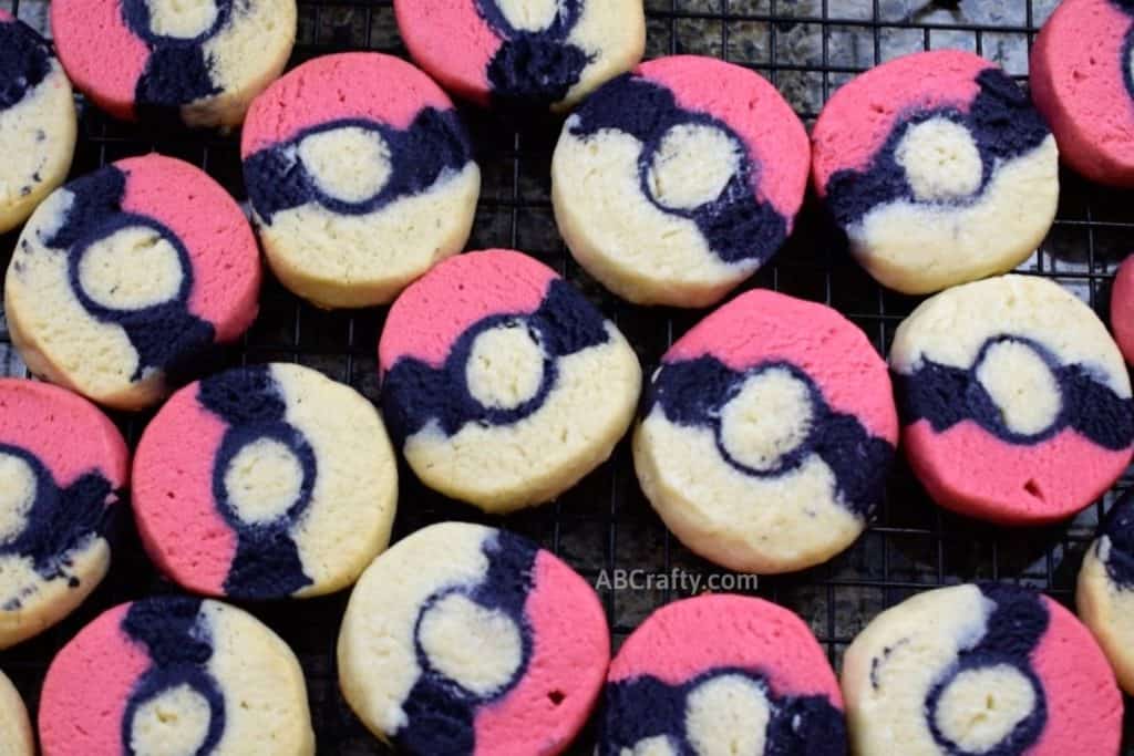 pokemon cookies on cooling rack in the shape of pokeballs