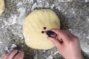 adding red food coloring to cookie dough